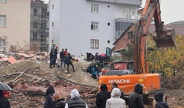 Ağır hasarlı bina yıkılırken iş makinesinin üzerine devrildi